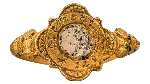 Gold Tudor England memento mori death head ring with skull motif and Latin inscription, symbolizing mortality and spiritual reflection.